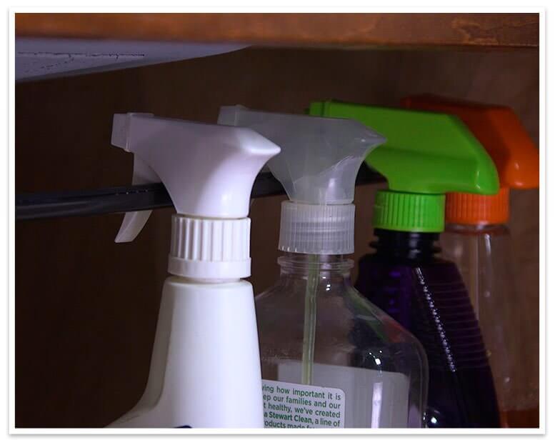 cleaning bottles hanging under sink